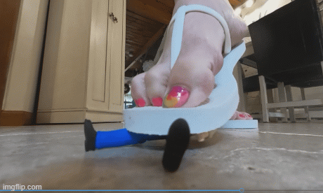 Madam steps on and crushes a number of tiny victims, wearing her Pulp Fiction outfit and white flip flops.  This clip is seen from your perspective from a standard POV angle.  Separate clips will show a VR version, as well as one from HER perspective in HD