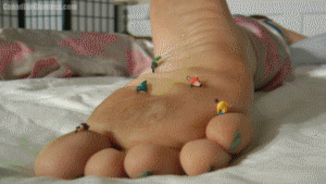 In her first video, Lady Demona rests in bed while unaware to her some very micro sized people are climbing up on the sole of her foot. She notices something though and her movements and brushing from her other foot knock the tiny people to the bed. In her sleep she picks a few from her hand too who are then smushed under her outspread palm. Another group finds themselves knocked down from her other foot and eventually she awakens to find another group down by her feet. They're crushed under her thumbs and a few good steps with her bare feet. She growls softly during this but otherwise Lady Demona stays quiet, assuming the things on the bed are just bugs. 5min 53sec.
